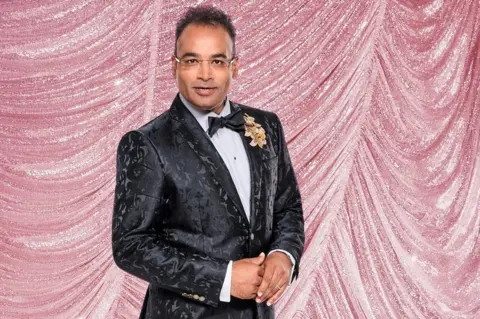 Ray Burmiston/BBC Krishnan Guru-Murthy in a black tuxedo