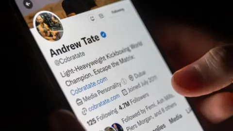 Getty Images Andrew Tate's Twitter profile open on a mobile phone screen