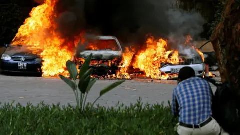 Reuters Cars are seen on fire in Nairobi, Kenya