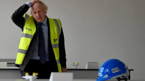 PA Media Boris Johnson wearing a high vis jacket