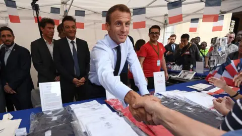 EPA President Emmanuel Macron shakes hands with a visitor at the Elysee Palace in Paris, 15 September 2018.