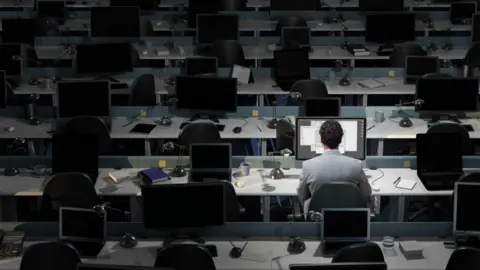 Getty Images Man at workstation alone - stock image