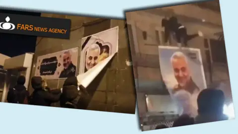 FARS/TWITTER/@ALINEJADMASIH Video of protesters tearing down and attacking posters of Qasem Soleimani