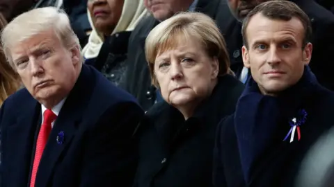 Getty Images Donald Trump, Angela Merkel and Emmanuel Macron