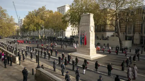 PA Media Veterans and military personnel stand by the Cenotaph