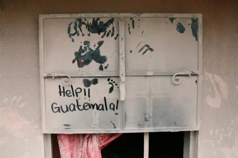 Reuters A sign on a widow covered with ash is seen at an area affected by the eruption of the Fuego volcano
