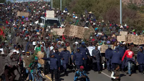 BBC Farmers take part in a march to parliament to protest against regulations forcing them to sell their wool and mohair to a Chinese broker, in Maseru, Lesotho, on June 28, 2019. Wool and mohair are key exports for farmers in Lesotho, but the government of the small southern Africa nation signed a monopoly deal last year with a Chinese broker who is accused of failing to pay for goods. About 30,000 farmers in Lesotho, which is entirely surrounded by South Africa, rely on wool and mohair exports.