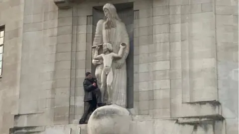 BBC A man attacks the Prospero and Ariel statue outside Broadcasting House