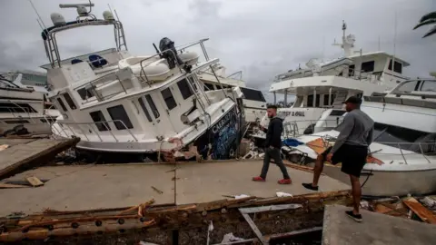 EPA Boats destroyed from Hurricane Ian swept onto the causeway.