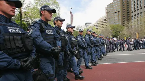Getty Images Australian Federal Police officers line up near a protest in 2007