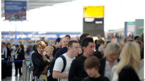 AFP Passengers waiting to check in at Heathrow