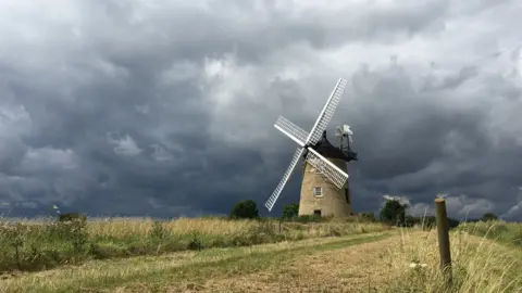 Geoff Stephens Great Haseley Windmill with storm clouds behind