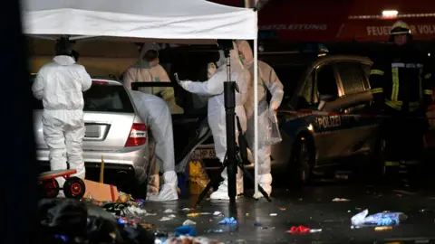 Getty Images Forensics teams examine a car in the German town of Volkmarsen