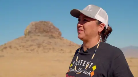 Ka'ila Farrell-Smith stands in front of Sentinel Rock