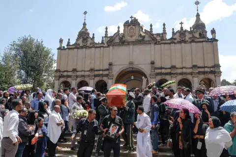 Getty Images Mourners and family members escort the coffins of the Ethiopian passengers and crew who perished in the Ethiopian Airways ET302 crash to a mausoleum at Selassie Church on March 17, 2019 in Addis Ababa, Ethiopia