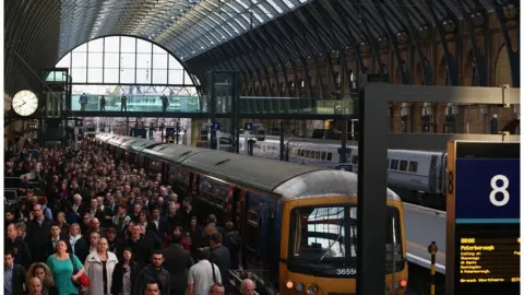 Getty Images Picture of commuters at Kings Cross station