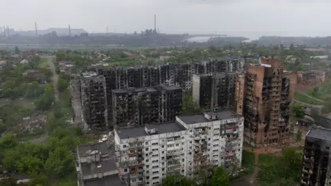 AFP An aerial view of damaged residential buildings and the Azovstal steel plant in the background in the port city of Mariupol on May 18, 2022