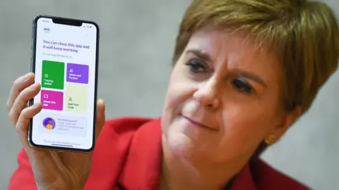 Getty Images Nicola Sturgeon with app