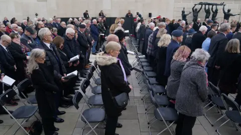 PA Media Veterans and the public observe a two minute silence during an Armistice Day service at the Armed Forces Memorial in the National Memorial Arboretum