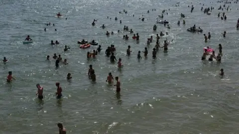 Reuters People and children enjoy the hot weather at Bournemouth Beach on June 17