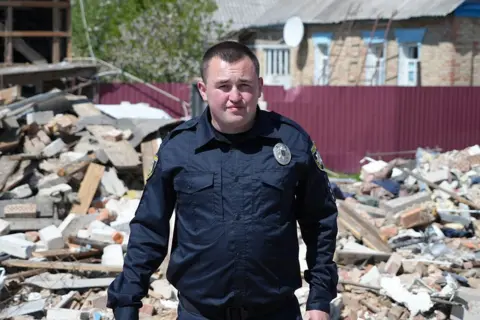 BBC/Duncan Stone Ivan Simoroz stands on what remains of the family home