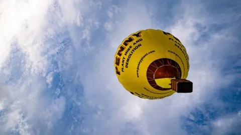 Ben Birchall/PA Wire One yellow hot air balloon