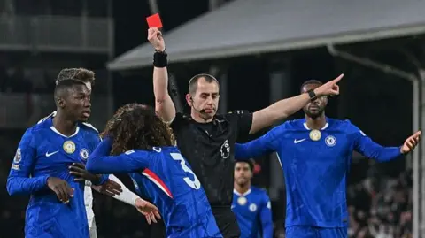 Marc Cucurella of Chelsea is shown a red card by referee Peter Bankes during the Premier League match between Fulham and Chelsea at Craven Cottage
