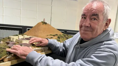 BBC/JO BURN Steve Timms with a model of the Roman fort of Dover.