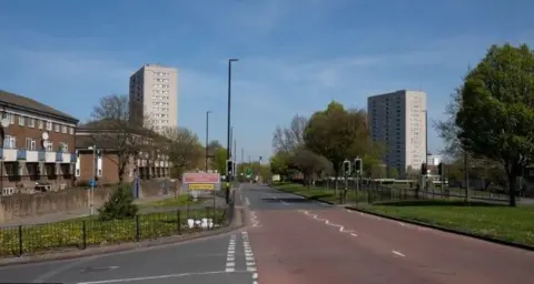 Getty Images A street with two high-rise flats in the distance