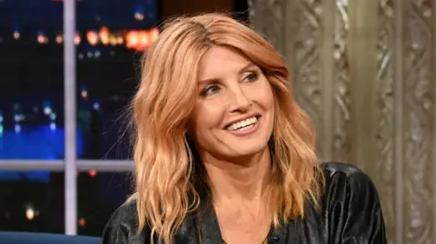 Sharon Horgan on The Late Show in November 2024. She has long strawberry blonde hair and is wearing a black dress.