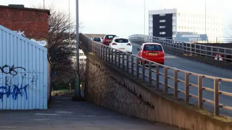 The Gateshead flyover with cars travelling upwards on to it.