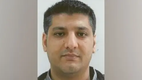 Crown Prosecution Service A mugshot of Baig, who has short salt and pepper hair and brown eyes. He looks straight at the camera.