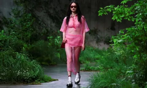 Reuters A model presents creations by Gucci at a fashion show in the Turbine Hall at Tate Modern, in London, Britain May 13, 2024. 