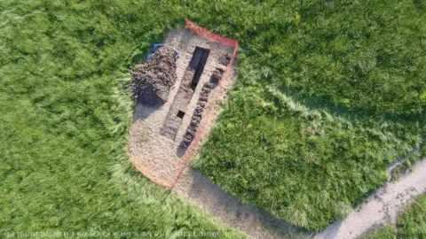 Andrew Wakeley/RWB Environment Trust An aerial image of a rectangular trench dug out with a pile of dirt next to it.