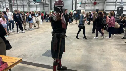 BBc A man dressed as a Mandalorian. 