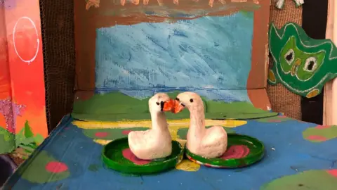 St Barnabas C of E Primary School An art piece of two swans and an owl in a colourful environment.