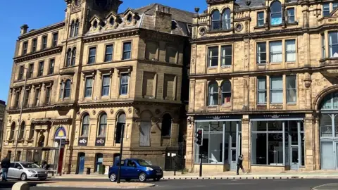 LDRS Large Victorian stone buildings on a busy city street