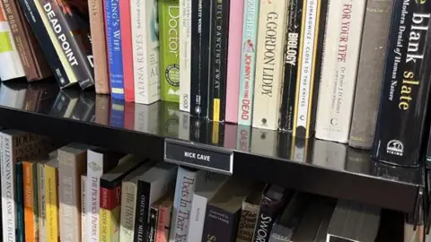 Juliette Parkin/BBC: There are a number of books that Nick Kaif donated, displayed at the OxFam Book in Hove, East Sussex.