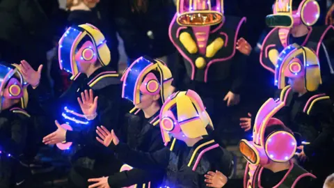 A line of children dressed as spacemen