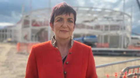 BBC Justice Secretary Angela Constance with steelwork of the new HMP Highland in the background