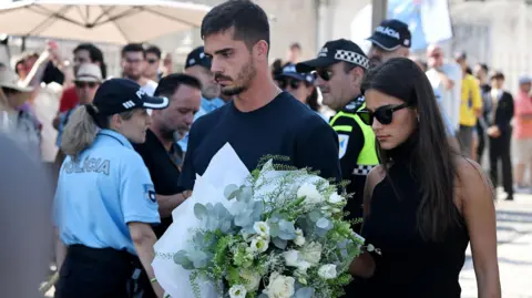 Andre Silva, football player at RB Leipzig and the Portuguese national team, and partner Maria Rodrigues attend a public wake held for Diogo Jota and his brother Andre Silva at the Capela da Ressurreicao. 