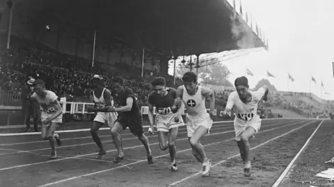 Getty Images Six athletes run in line on track at Colombes stadium in the men's 1500 metres event at the 1924 Summer Olympics in Paris