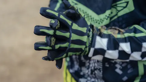 Harry George Hall Close up of gloves with a skeleton bone design