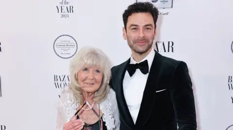 Getty Images Dame Jilly Cooper and Aidan Turner smile 