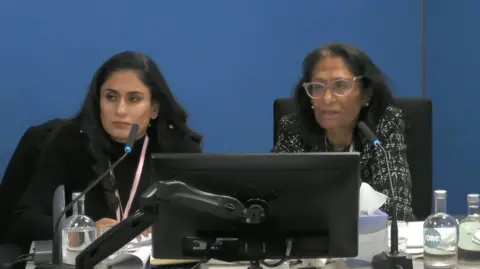 Undercover Policing Inquiry Woman with long hair and older woman with long hair and glasses looking ahead