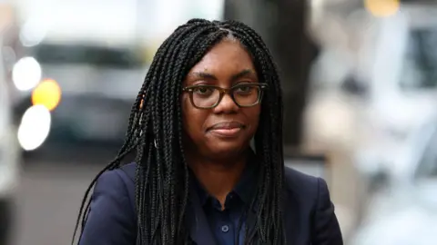 Getty Images Kemi Badenoch wears a dark navy suit as she arrives at the Post Office inquiry