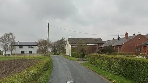 Houses amid fields in Fir Tree Lane, Aughton