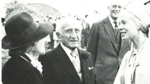 Sobell House A black and white image of Lady Sobell, Sir Michael Sobell and Katharine, the Duchess of Kent in 1976. The women are wearing hats.