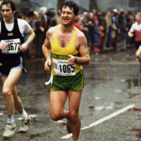 Mac Speake Mac wearing a yellow running vest and green shorts