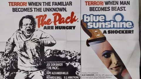 Hansons A composite image of film posters for The Pack and Blue Sunshine. The Pack film poster includes the words: "Terror! When the familiar becomes the unknown. The Pack are hungry." It includes a black and white sketch of a man running away and screaming. The Blue Sunshine poster includes the words: "Terror! When man becomes beast. Blue Sunshine. A shocker". It features a knife with a woman's face in the blade.